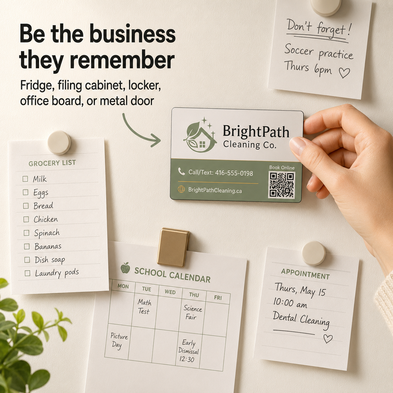Hand placing a business card on a refrigerator with notes and a plant.