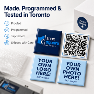 Custom square magnets shown on a clean white background with promotional text reading 'Made, Programmed & Tested in Toronto' and feature checkmarks. The set includes a dark navy magnet with a logo placeholder, a black-and-white QR code sample, and two light blue magnets with 'YOUR OWN LOGO HERE!' and 'YOUR OWN PHOTO HERE!' text.