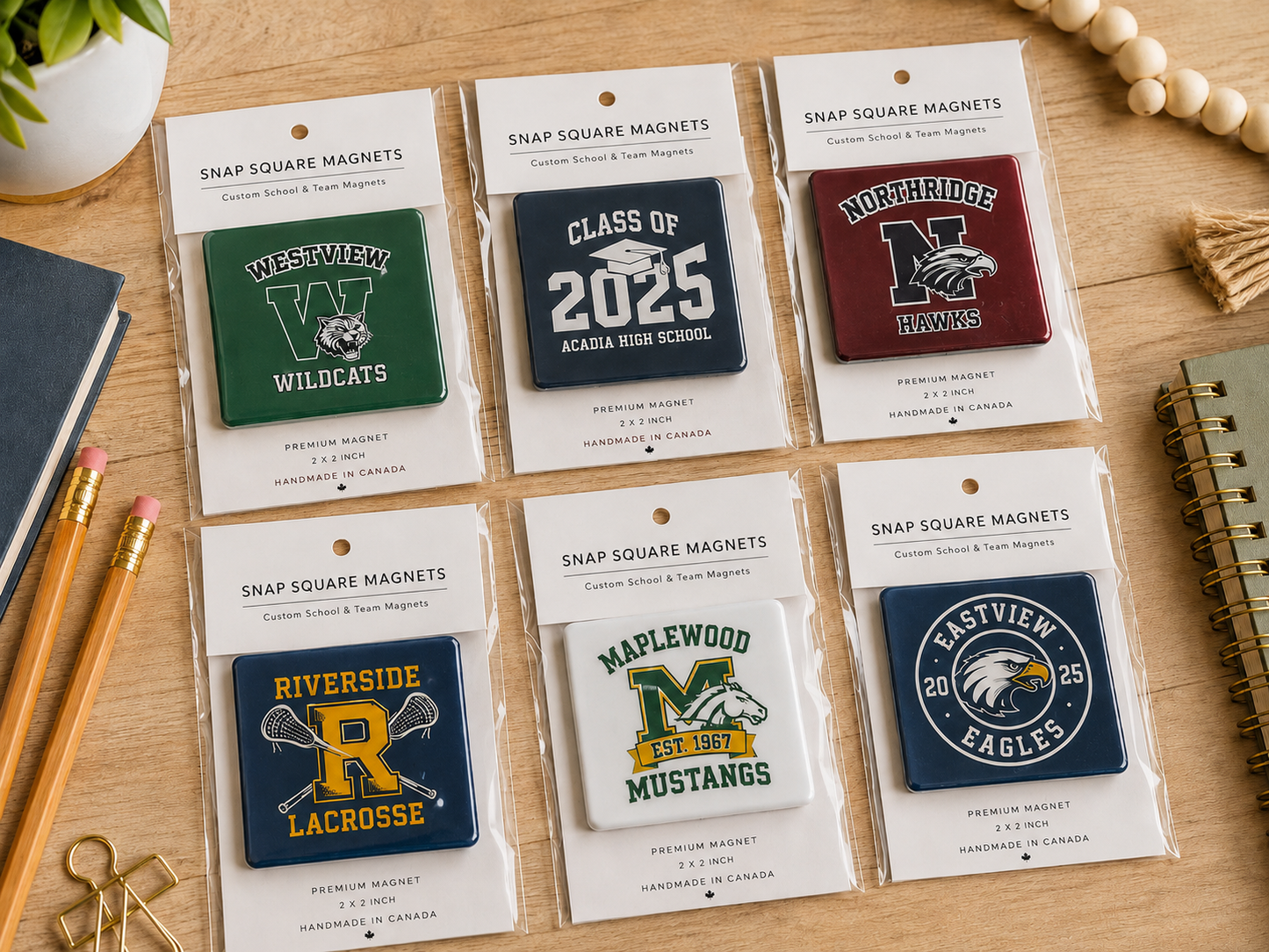 Collection of snap square magnets with various designs on a wooden surface.