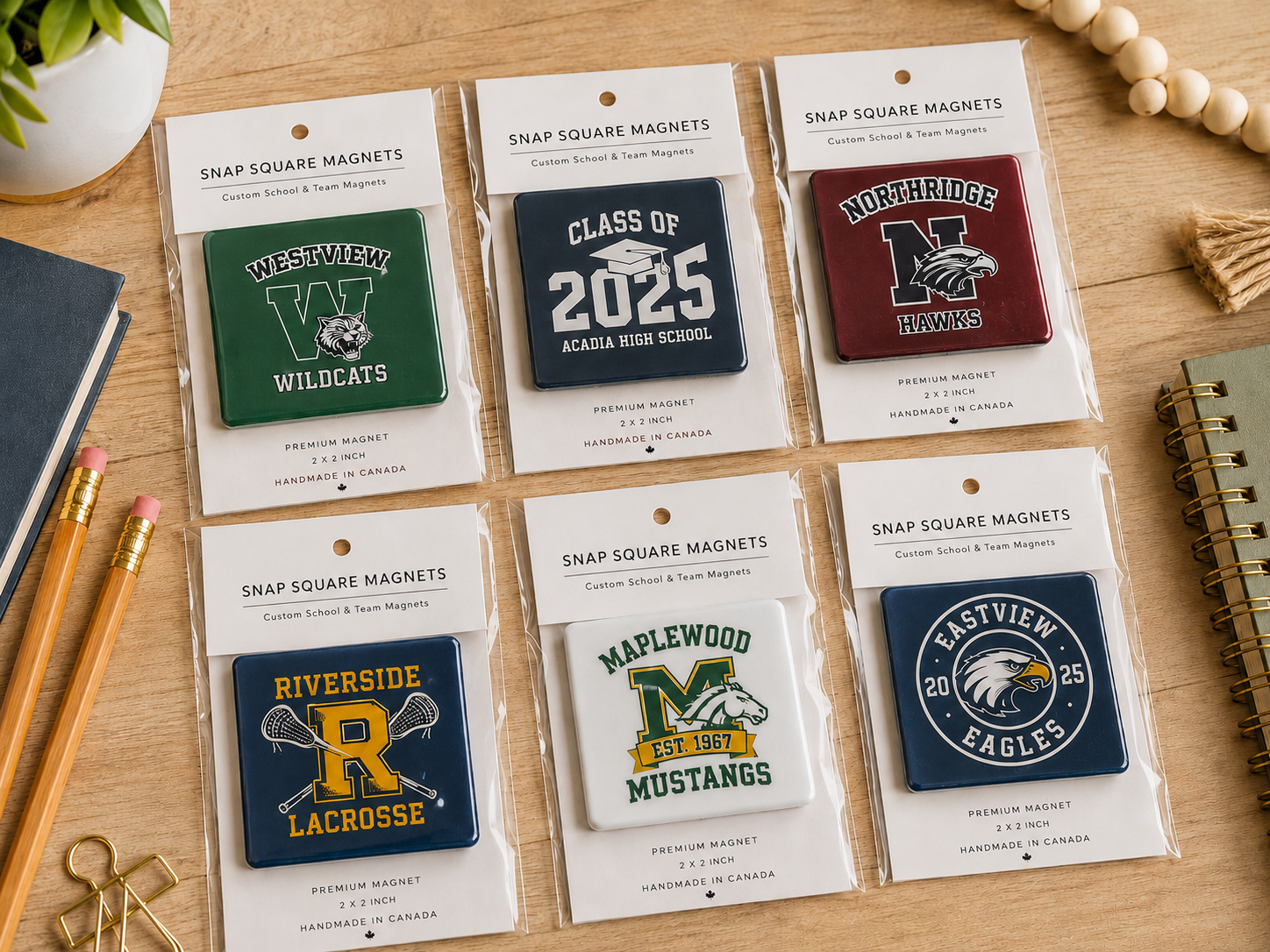 Collection of snap square magnets with various designs on a wooden surface.