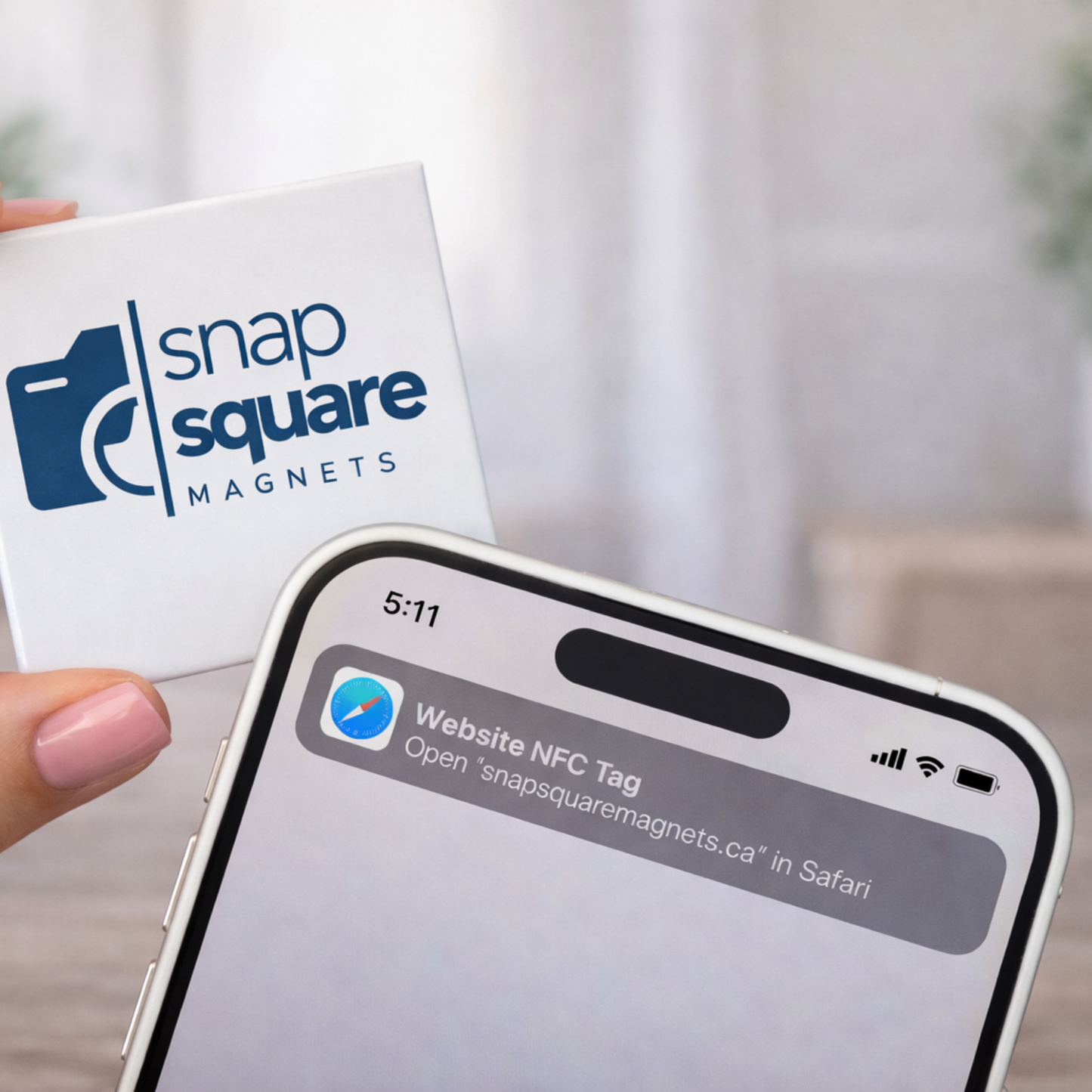 Smartphone with NFC tag prompt held by a hand, next to a Snap Square Magnets card.